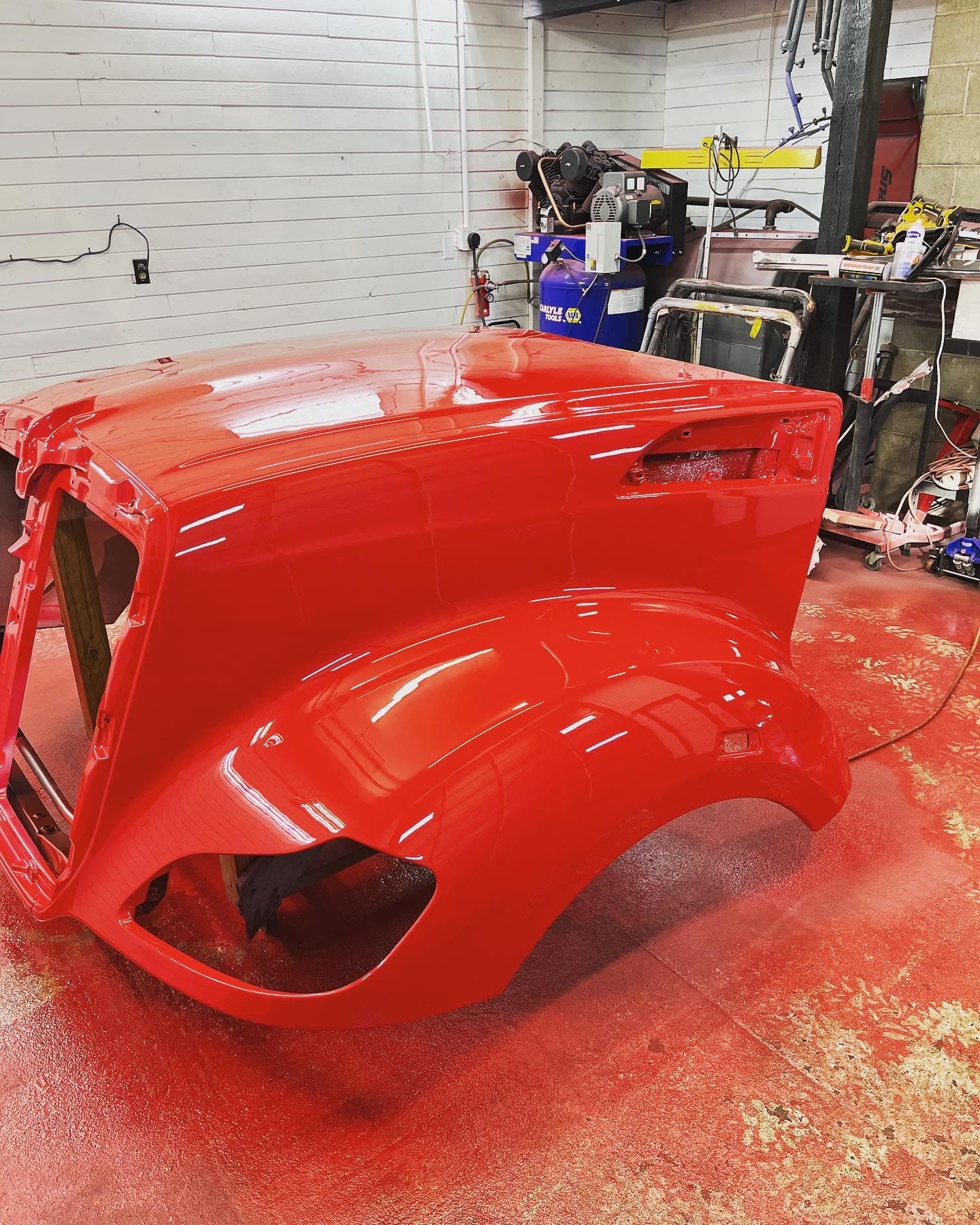 Semi-truck cab hood with custom red paint job by JRB Autobody